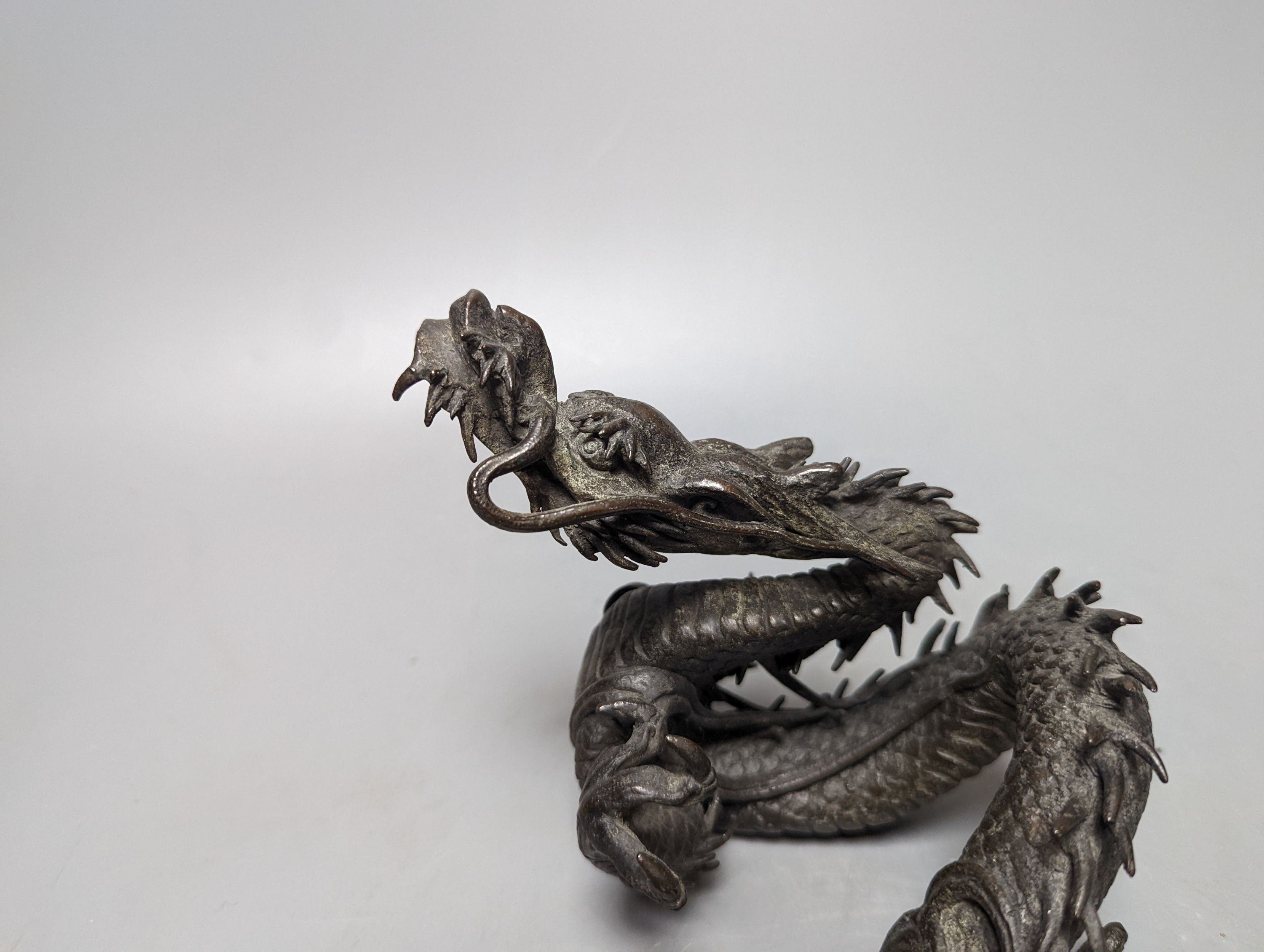 A pair of early 20th century Japanese bronze figures of dragons 22cm